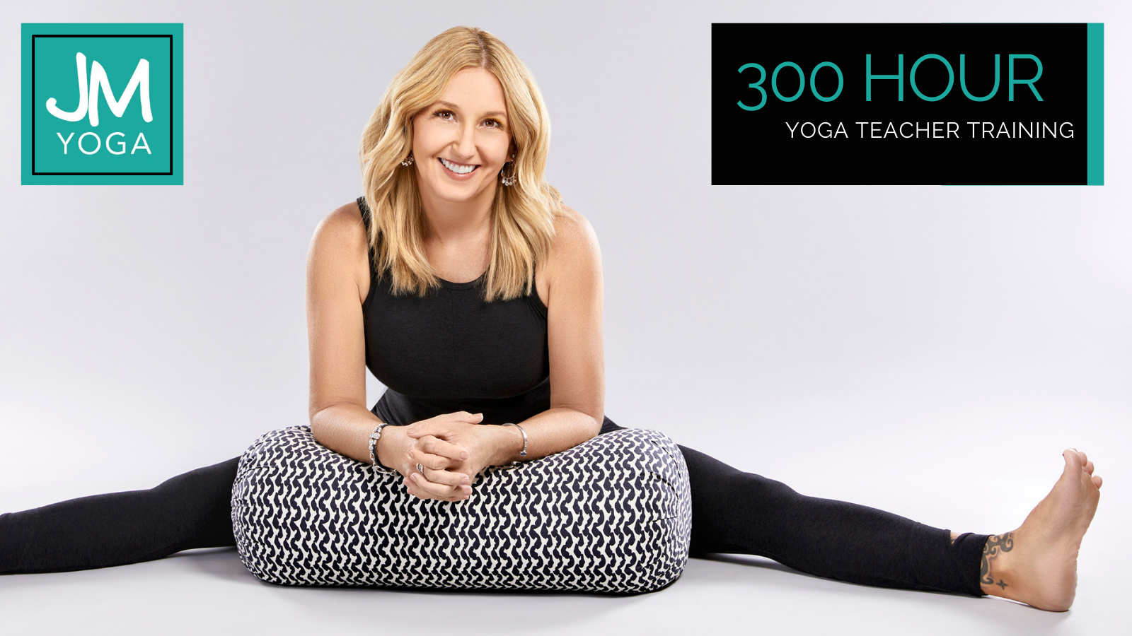Promotional graphic for the 300hr yoga teacher training with Jules sitting in upavista konasana resting on a black and white bolster.