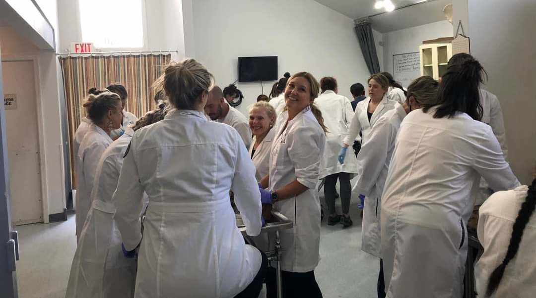 Jules and her lab participants in lab coats working