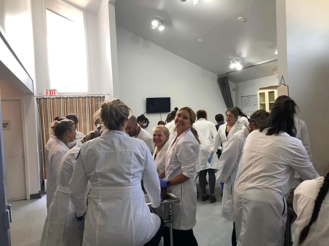Jules and her lab participants in lab coats working