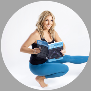 Photo of Jules in a squat position with one foot propped up on a stack of yoga blocks. She is smiling at the camera and holding a copy of her book. The photograph is in a circle shape with a gray background.